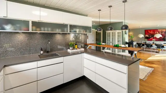Stilrent kjøkken med god skapplass og store vinduer